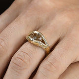 Discover the Annette Ring, featuring a 2 ct oval champagne diamond set in a luminous diamond halo. An alternative engagement ring handcrafted in 14K gold