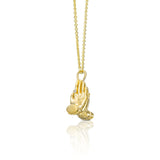 Angled view of a 14K gold Mini Namaste necklace with sculptural praying hands and gemstone accents.