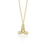Sculptural gold Namaste pendant with diamond details, natural emerald and ruby on a fine gold chain.