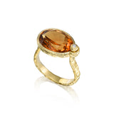 5.6ct oval citrine ring with vivid sunset-orange hues, small diamond accent and hand-carved textured 14K yellow gold band.