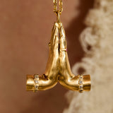 front view 14K gold Namaste necklace featuring sculpted praying hands with natural diamonds, emerald and ruby.