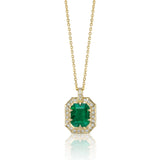 Emerald-cut natural emerald necklace with diamond surround and hand-carved 14K yellow gold pendant.