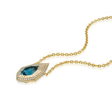 Angled view of blue-green lagoon tourmaline and natural diamond necklace with geometric 14K yellow gold pendant.