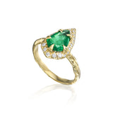 Pear-shaped natural emerald and diamond ring with elongated diamond detailing and sculptural textured 14K yellow gold band.