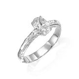 Angled view of 1 ct natural oval diamond engagement ring with hand-carved textured 14K white gold band.