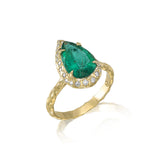 pear shaped emerald ring with diamond halo and textured band