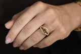 Oval champagne diamond halo ring in textured 14K gold with a floating diamond effect and diamond halo