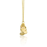 14K gold Namaste necklace featuring sculpted praying hands with natural diamonds, emerald and ruby.